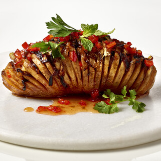 Vegan Hasselback Potato with Red Pepper Jelly and Caramelized Onions