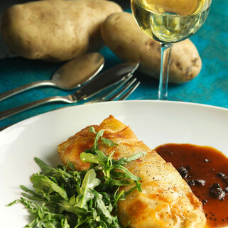 Idaho® Potato Crusted Black Bass with Black Truffle Sauce and Wild Arugula