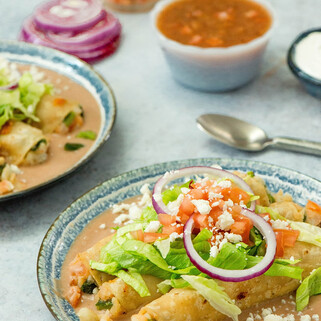 Potato Flautas with Poblano Pepper, Oaxaca Cheese on Bean Purée
